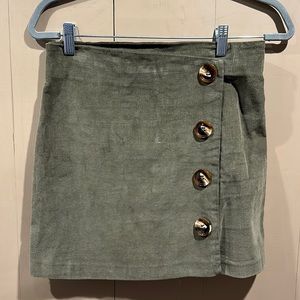 Altar’d State green mini skirt with buttons.